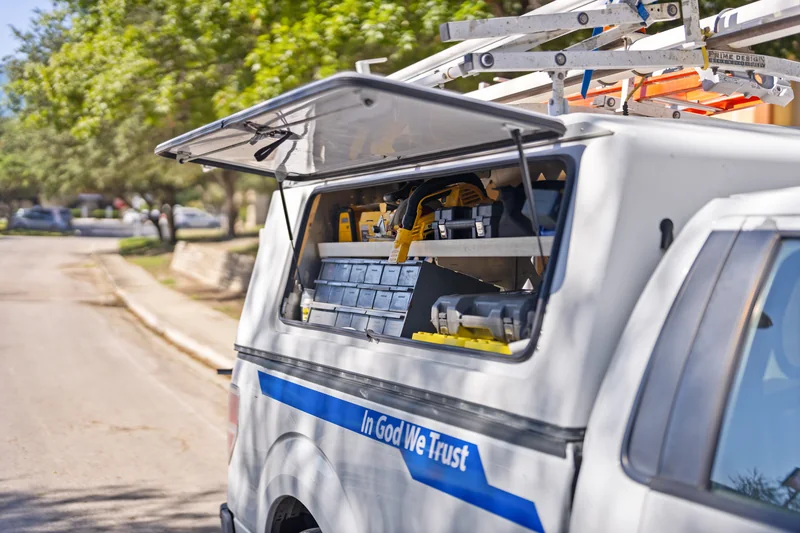 Open tool compartments on the side of an H2O Plumbing Authority service truck