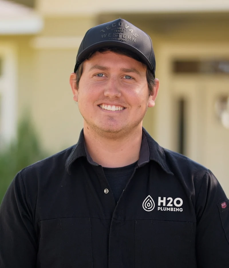Caleb Hopkins, owner of H2O Plumbing Authority, wearing his company shirt