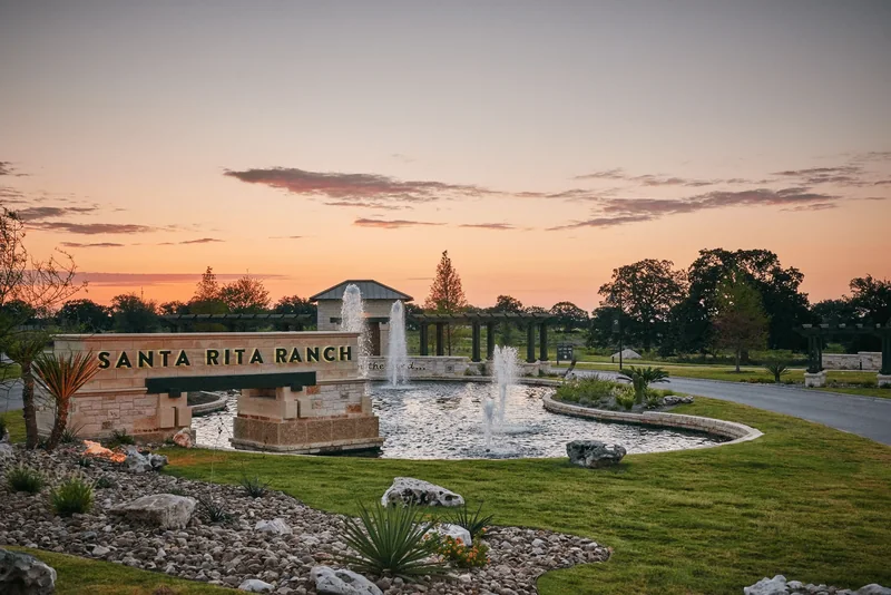 Santa Rita Ranch entrance at sunset Santa Rita Ranch entrance sign and fountains beneath a sunset sky.